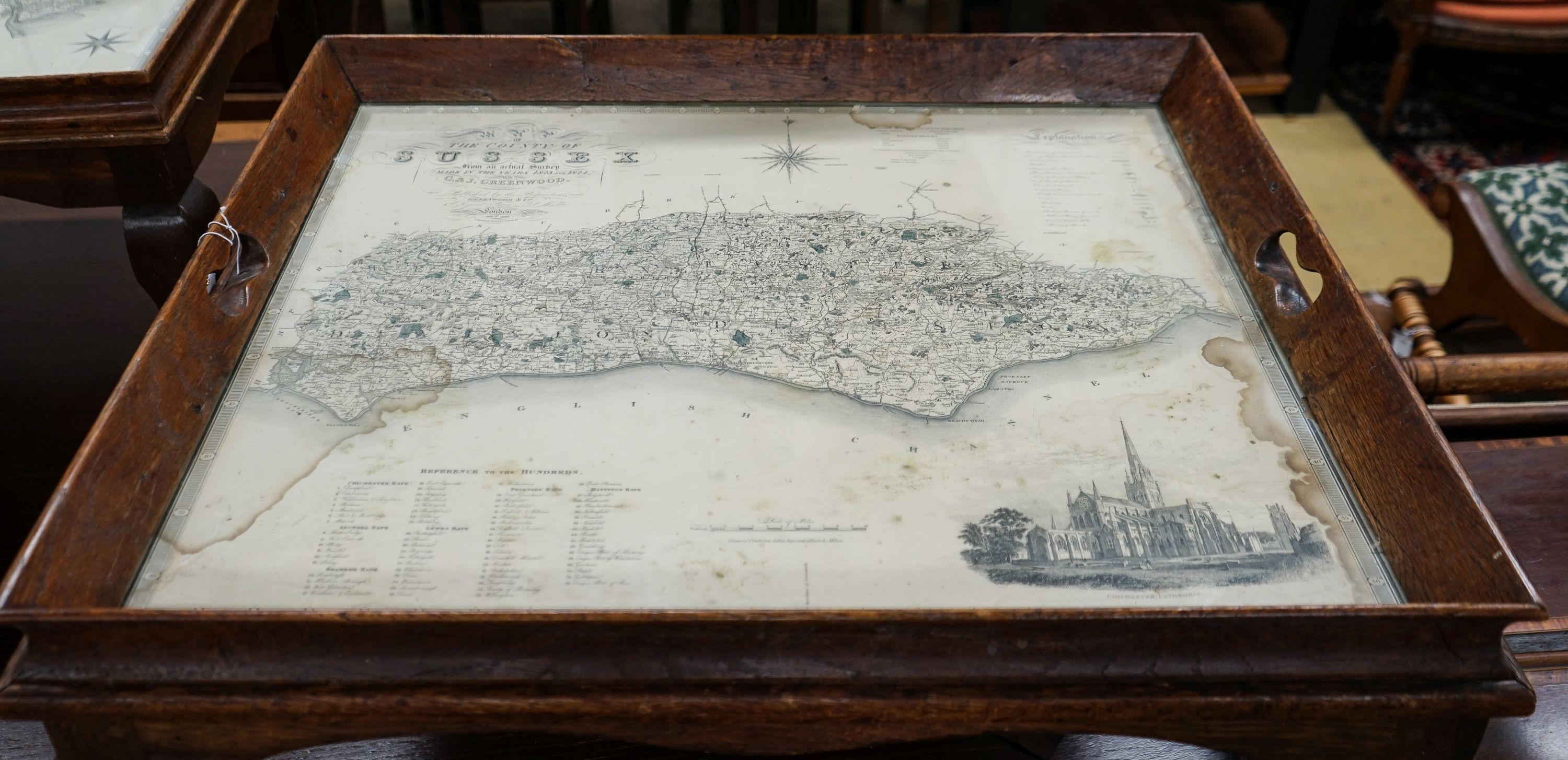 A rectangular oak tray top low table inset with a map of Sussex on ball and claw stand, width 81cm, depth 70cm, height 47cm